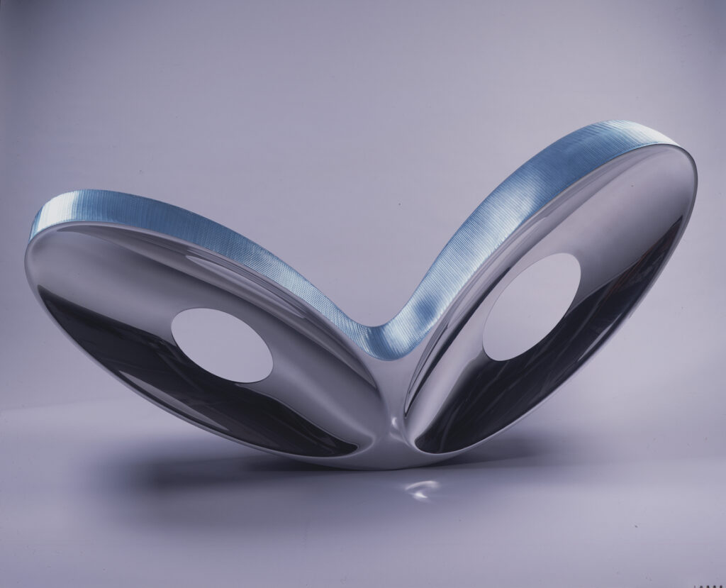 Chair formed by two oblong loops resembling wings made of mirror polished aluminum alloy