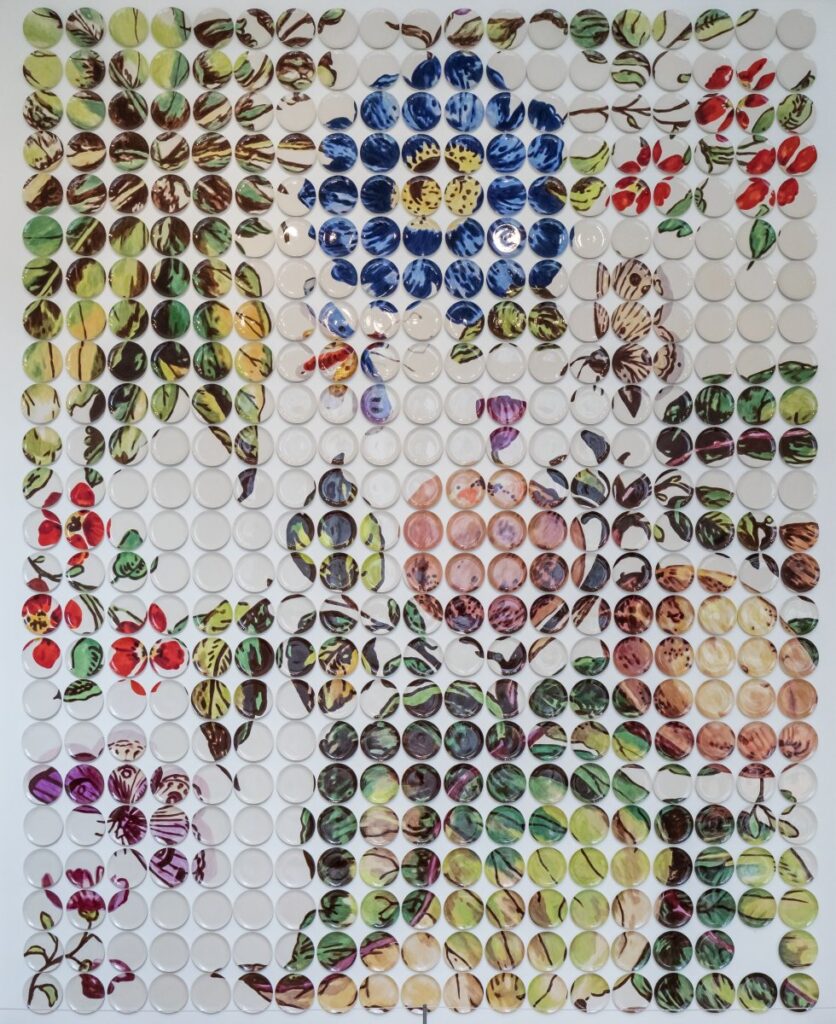 a grid of hand painted plates combine to depict leaves and flowers.