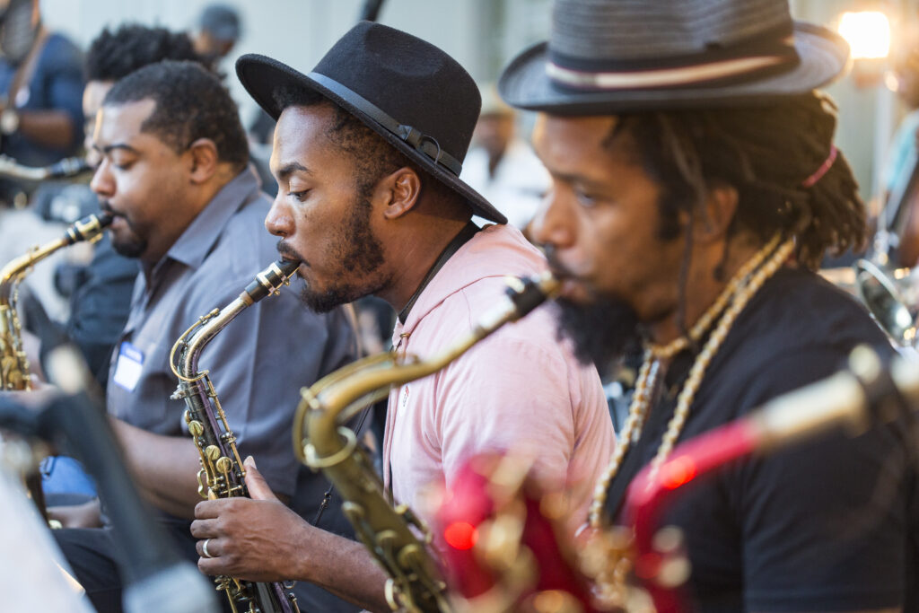High Museum Jazz Night three men with brown skin and hats playing the saxaphone.