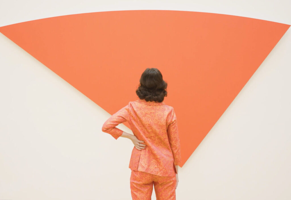 membership woman in front of ellsworth kelly Women in all red outfit stands in front of Ellsworth Kelly's Red Curve VI