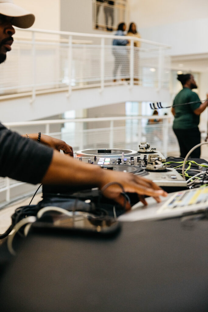 A man uses DJ equipment in the High Museum of Art's atrium